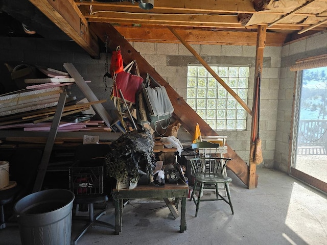 interior space featuring concrete block wall and concrete floors