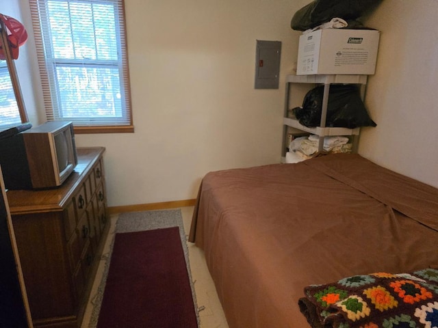 bedroom with electric panel and baseboards