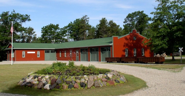 view of property with an attached garage and gravel driveway