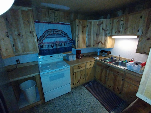 kitchen featuring a sink, light countertops, and white range with electric stovetop