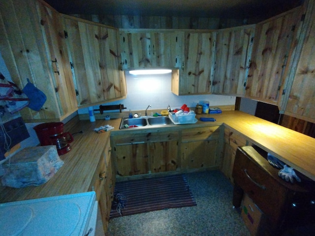 kitchen featuring a sink, light brown cabinetry, and light countertops