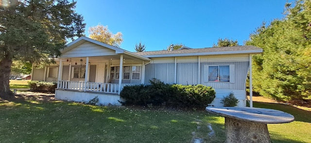 view of front of home with a porch and a front lawn