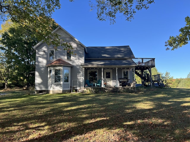 view of front of home featuring stairs and a front yard