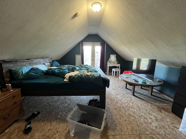 bedroom featuring a textured ceiling and lofted ceiling