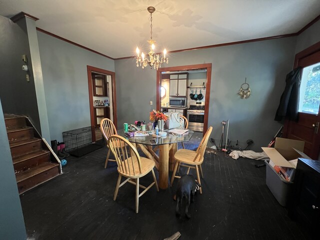 dining area with crown molding, an inviting chandelier, and wood finished floors