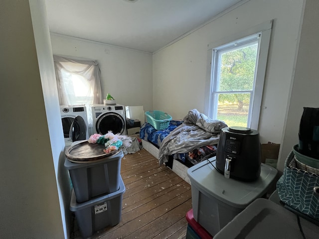 bedroom featuring hardwood / wood-style floors and washing machine and dryer