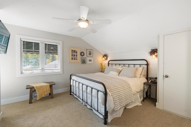 carpeted bedroom with ceiling fan, baseboards, and vaulted ceiling