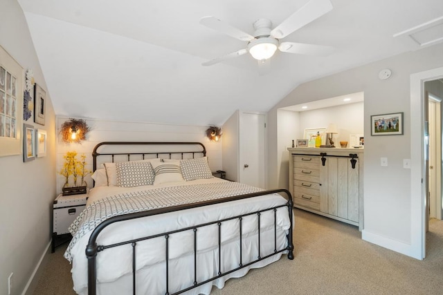 bedroom with baseboards, attic access, ceiling fan, vaulted ceiling, and light colored carpet