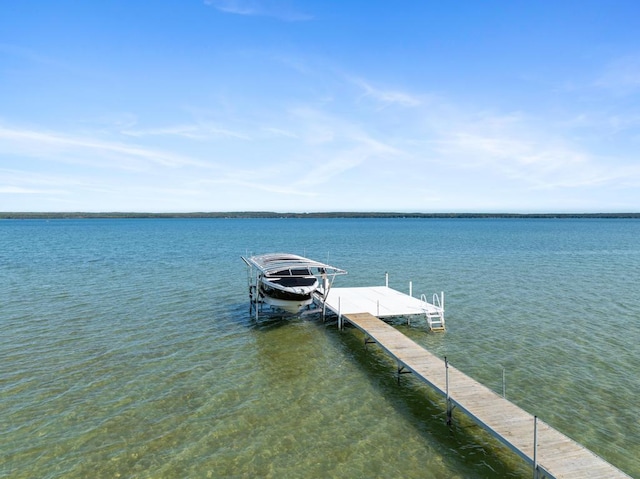 dock area featuring boat lift and a water view