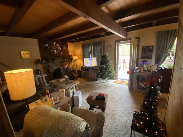 living room with beam ceiling, a brick fireplace, wooden ceiling, and carpet