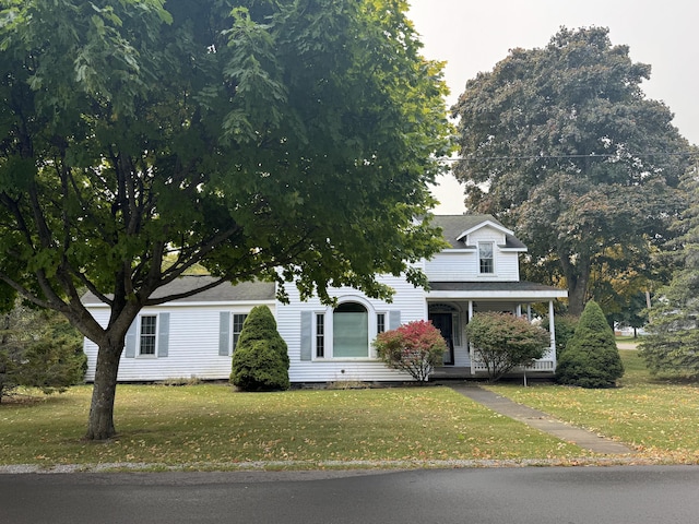 view of front of home featuring a front yard and a porch