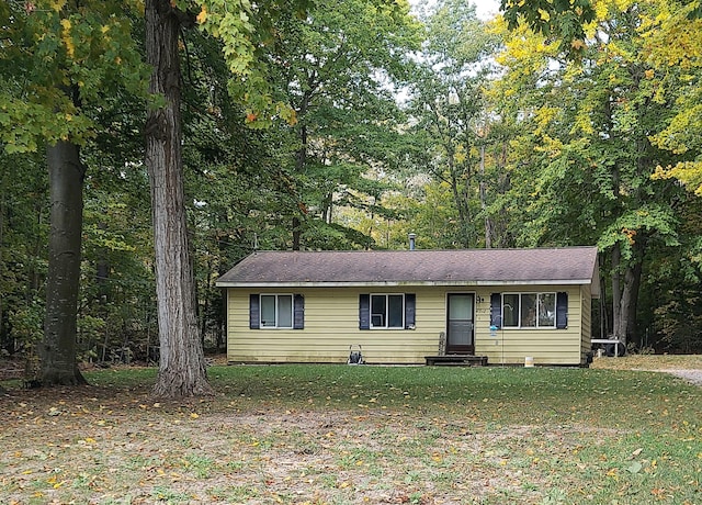 ranch-style house featuring entry steps and a front lawn