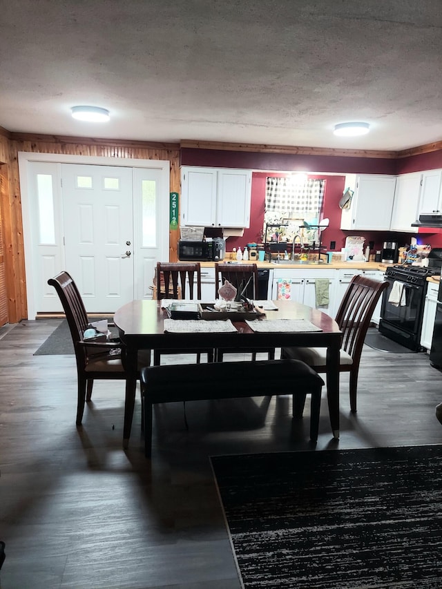 dining room featuring dark wood-style floors and a textured ceiling