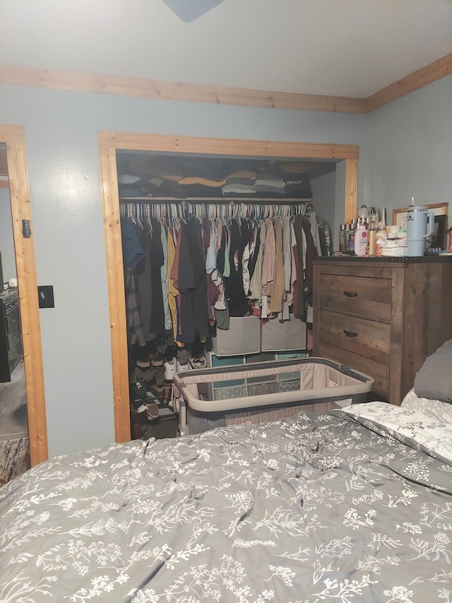 bedroom featuring a closet and crown molding