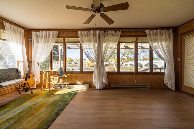 unfurnished sunroom featuring a baseboard radiator and a baseboard heating unit