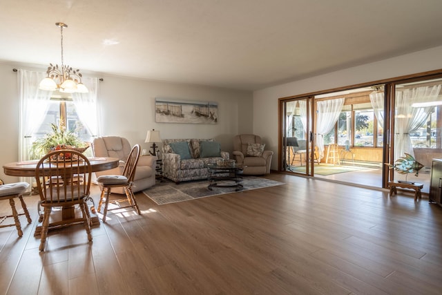 living room with a notable chandelier and wood finished floors