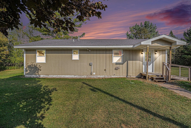 view of front of property with a front lawn and a shingled roof