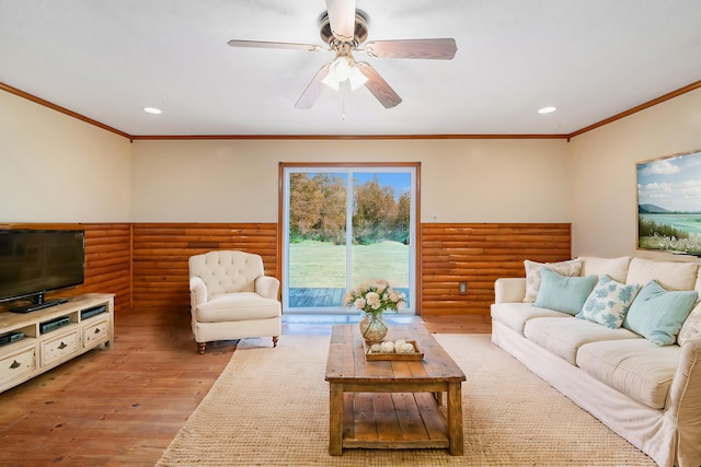 living area featuring recessed lighting, wood finished floors, and crown molding