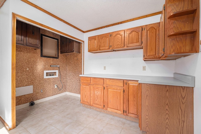 kitchen with baseboards, light countertops, brown cabinets, a textured ceiling, and open shelves