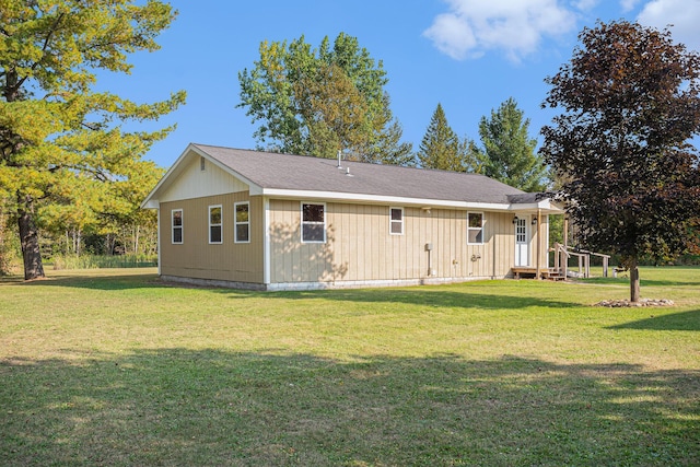 back of property featuring a yard