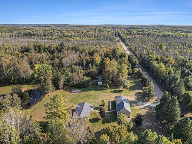 birds eye view of property featuring a view of trees