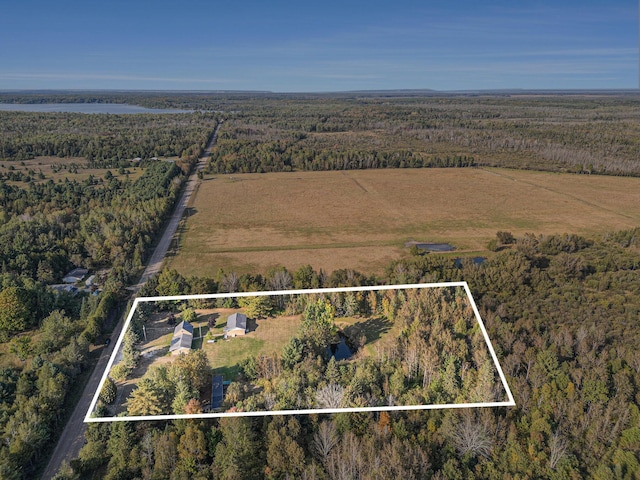 aerial view featuring a rural view and a wooded view