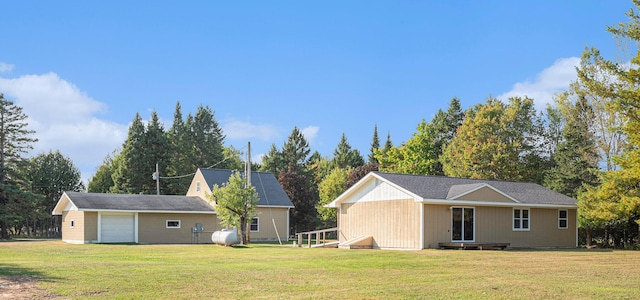 back of house featuring a garage and a yard