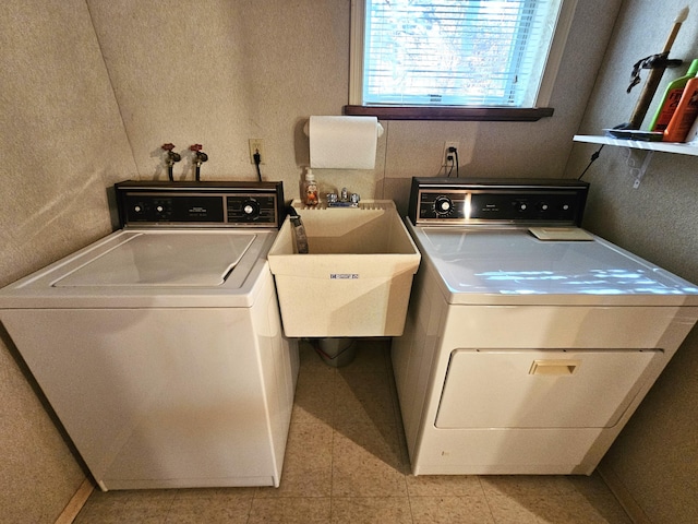 laundry area featuring laundry area, washer and dryer, and a sink