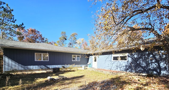 back of property with roof with shingles