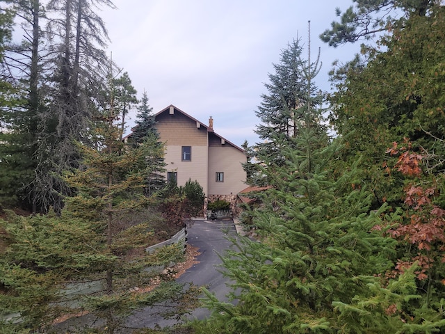 view of property exterior featuring a chimney