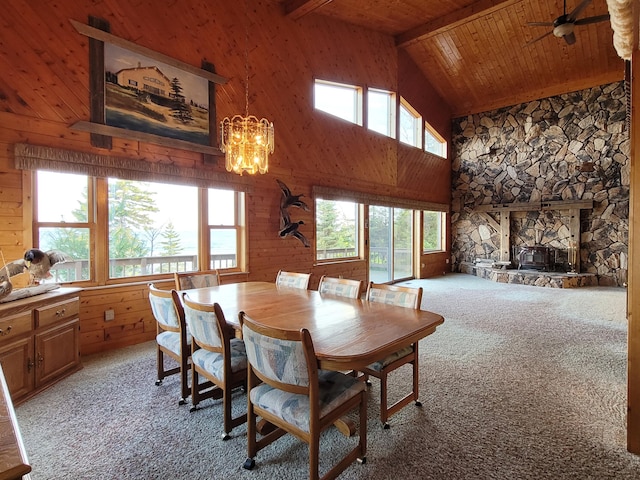 dining space featuring wooden ceiling, beamed ceiling, a wealth of natural light, and light carpet