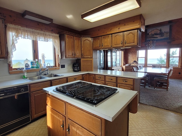 kitchen with stovetop with downdraft, light floors, dishwasher, and a sink