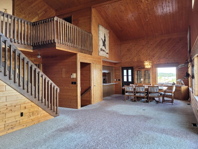 living area featuring wooden ceiling, wooden walls, and carpet