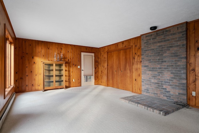 unfurnished living room with carpet flooring, wood walls, and baseboard heating