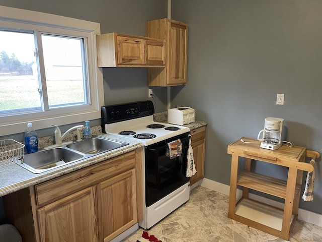 kitchen featuring electric range, light countertops, baseboards, and a sink