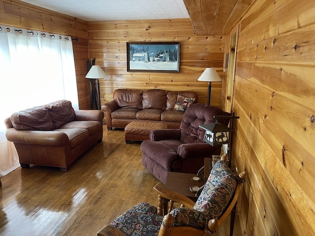 living area featuring wood walls and hardwood / wood-style flooring