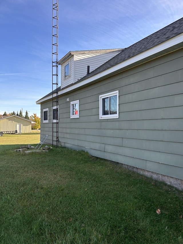 view of side of property with a lawn