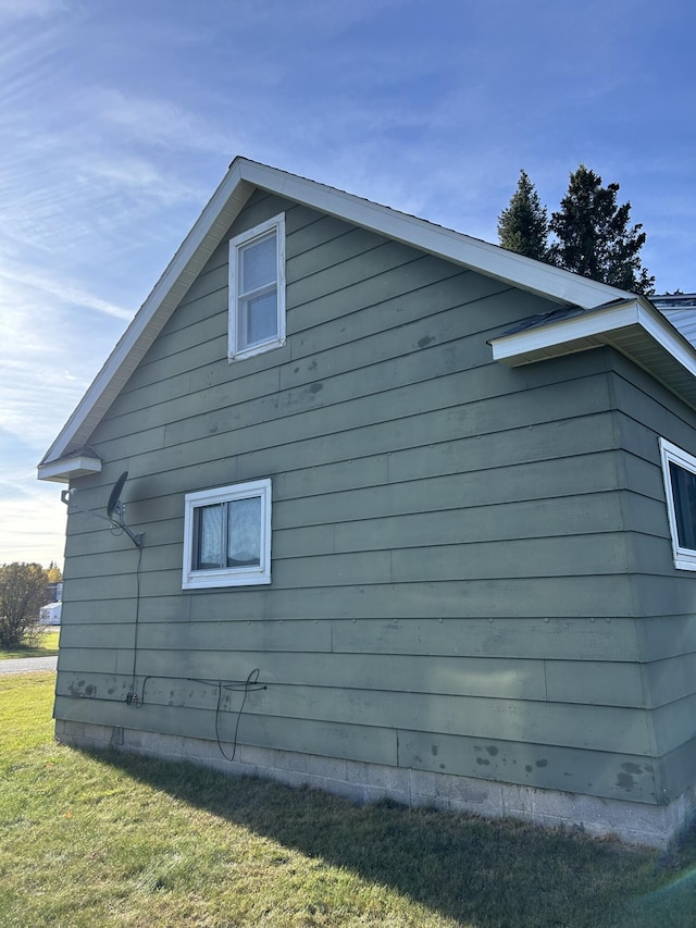 view of side of property with a yard