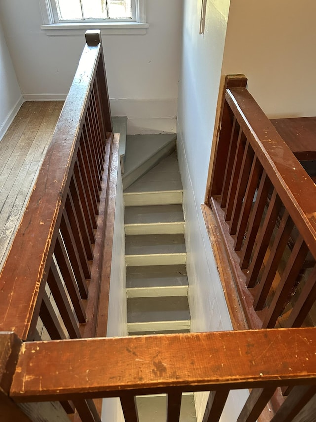 stairs featuring baseboards and hardwood / wood-style flooring