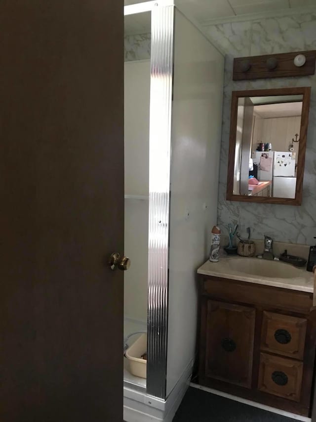 bathroom with washer / dryer and vanity