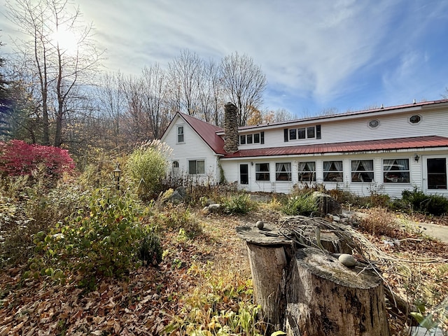 6658 M-33, Onaway, MI 49765 - back of house with a chimney and metal roof