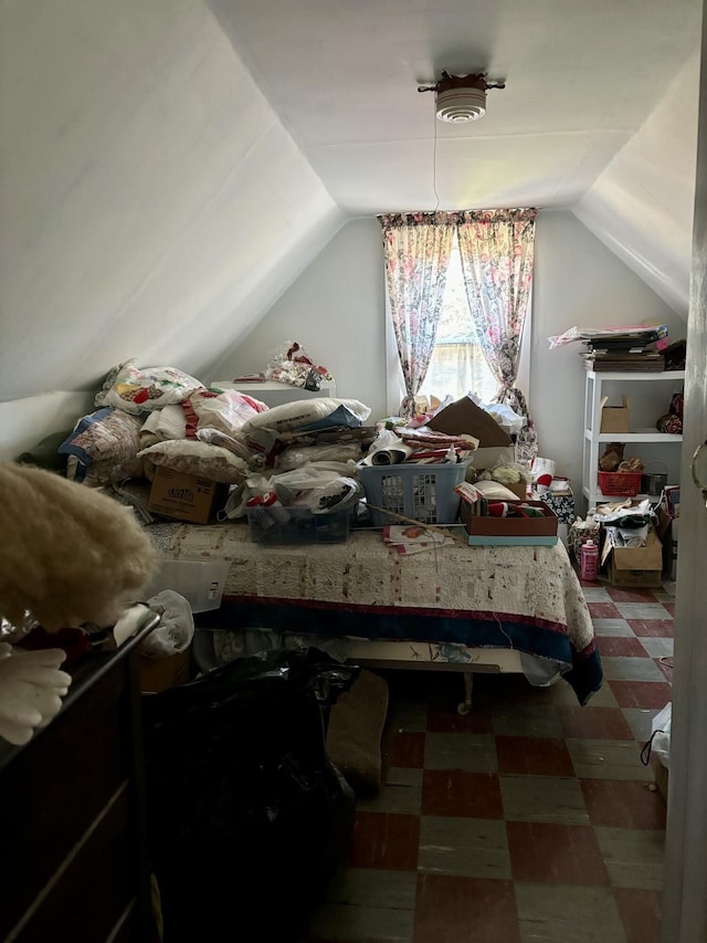 bedroom featuring lofted ceiling and tile patterned floors