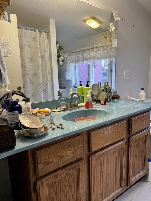 bathroom featuring tile patterned floors, a textured ceiling, vanity, and a shower with curtain