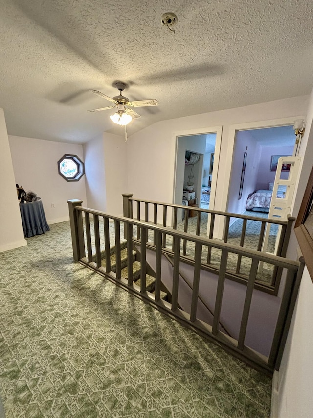 6658 M-33, Onaway, MI 49765 - staircase featuring carpet flooring, a textured ceiling, and a ceiling fan