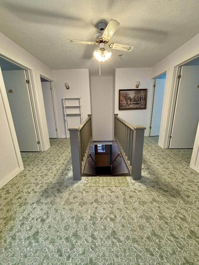 6658 M-33, Onaway, MI 49765 - corridor featuring an upstairs landing and a textured ceiling