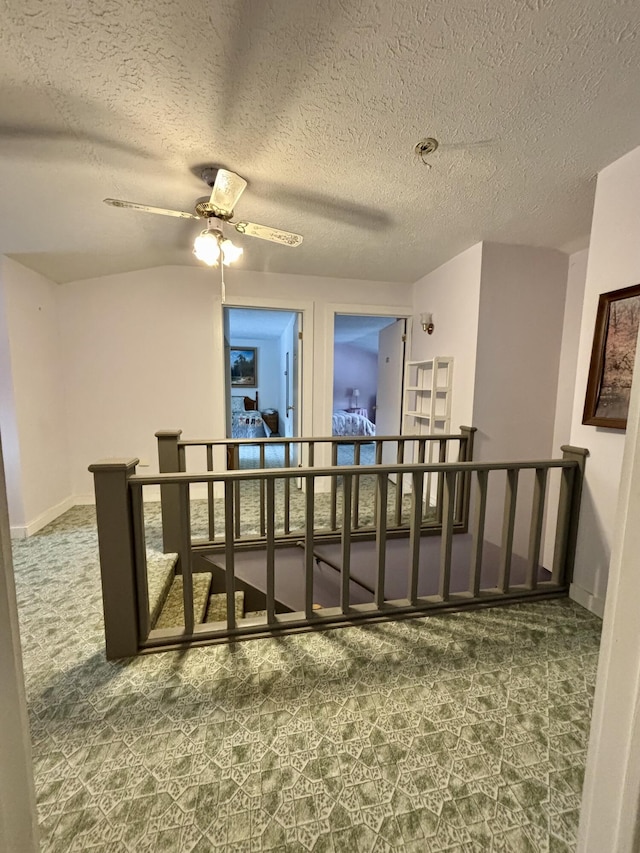 6658 M-33, Onaway, MI 49765 - interior space featuring baseboards, carpet, and a ceiling fan