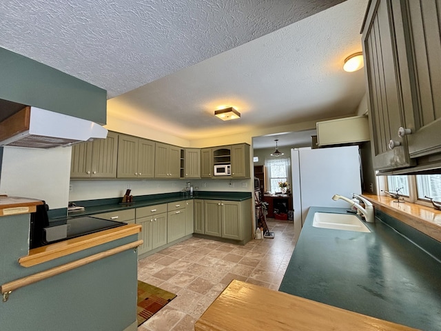 6658 M-33, Onaway, MI 49765 - kitchen featuring a sink, dark countertops, white appliances, green cabinets, and glass insert cabinets