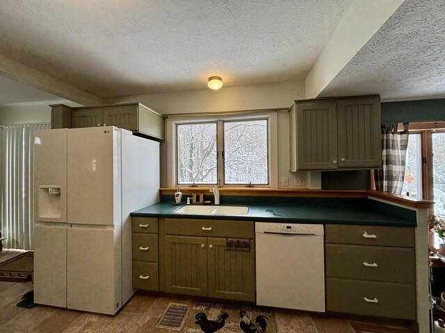 6658 M-33, Onaway, MI 49765 - kitchen featuring visible vents, a sink, plenty of natural light, dark countertops, and white appliances
