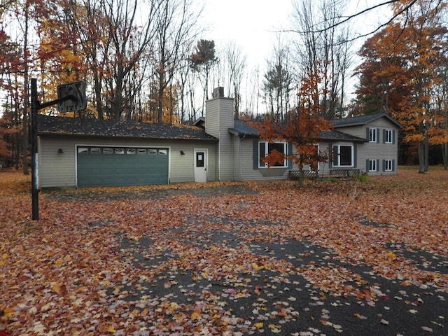 exterior space with a chimney and a garage