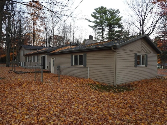 rear view of property with a chimney